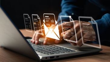 Person's hands typing on a laptop overlaid by a digital illustration of an envelope and document to represent creating an invoice on a computer. 